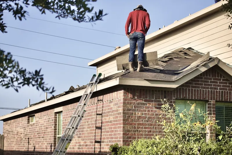 Professional roofer working on a residential roof in Postil